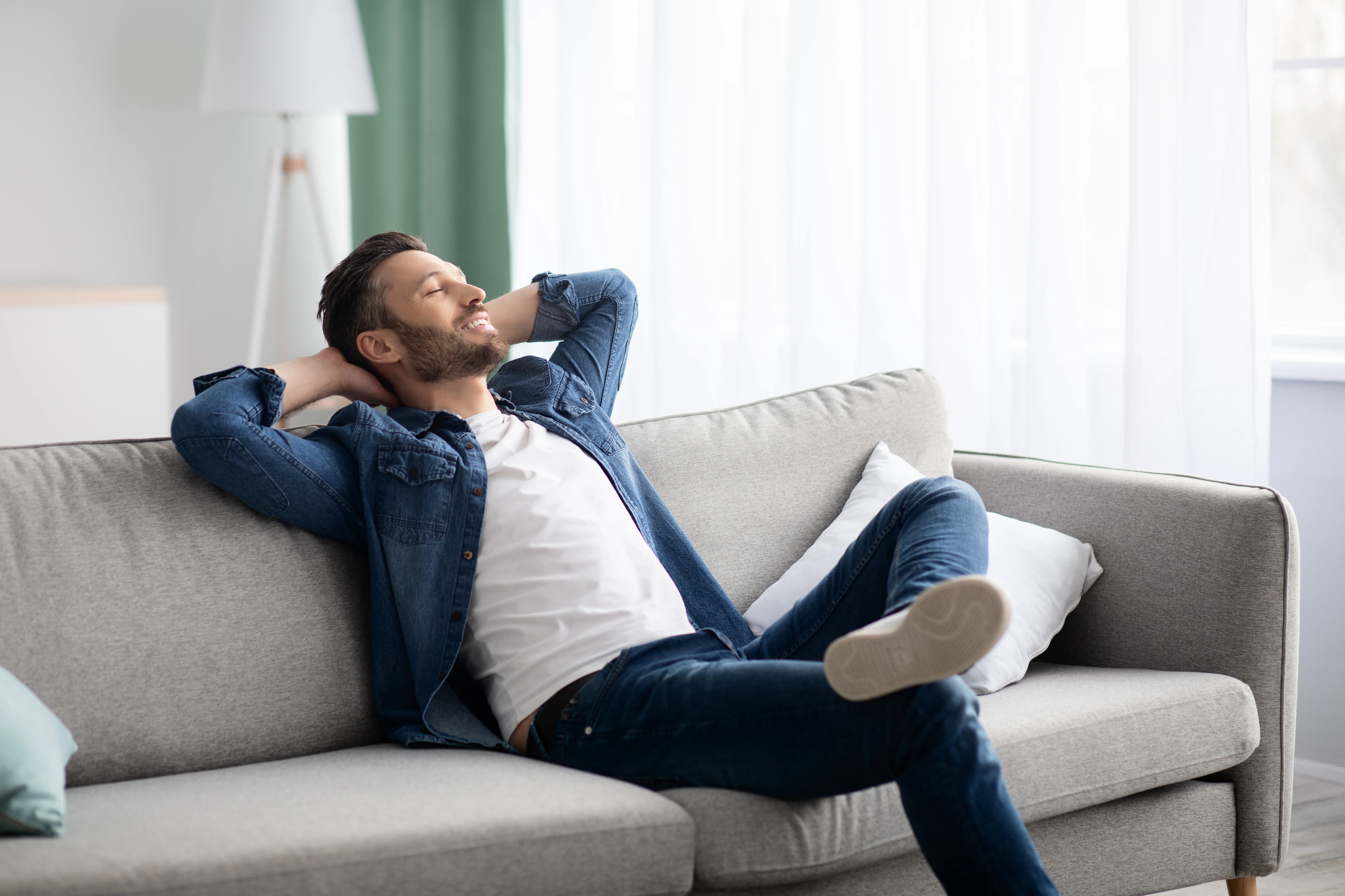 A Birmingham homeowner relaxing on his couch in a fresh-smelling, allergen-reduced home